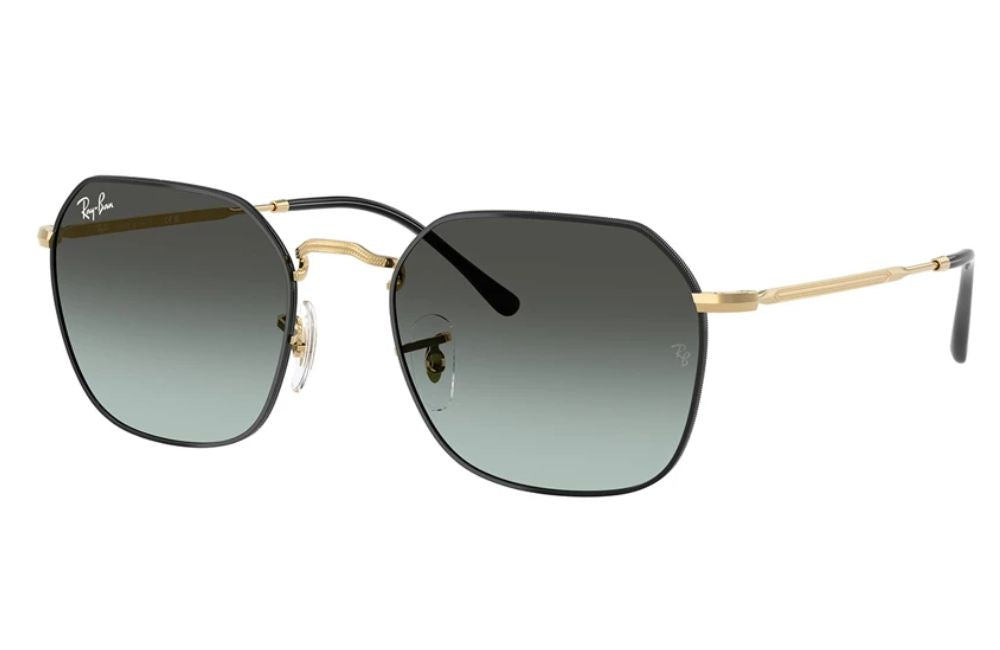 Sunglasses with gold frame and black gradient lenses on a white background