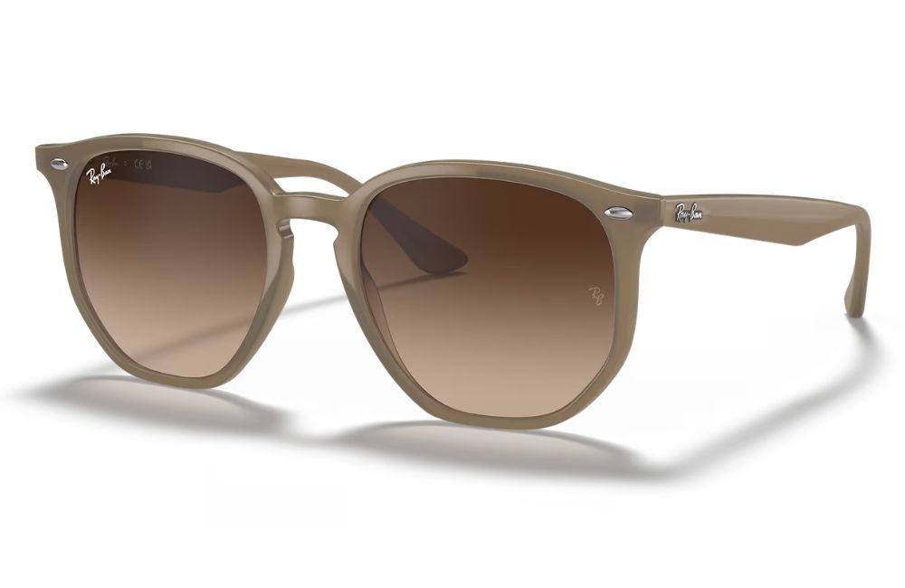 Beige sunglasses with brown gradient lenses on a white background