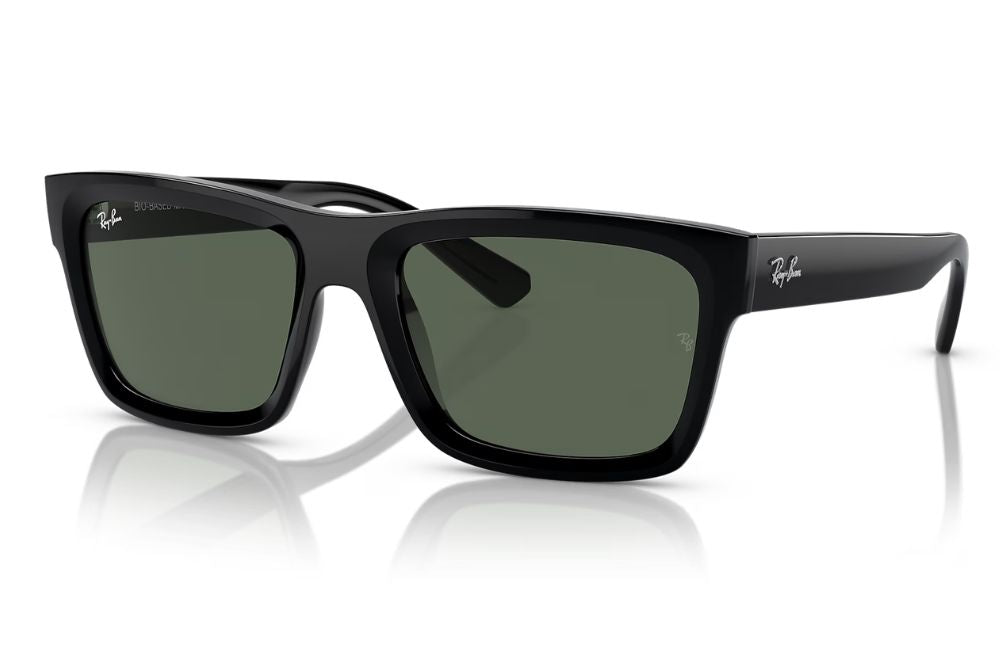 Black sunglasses with green lenses on a white background