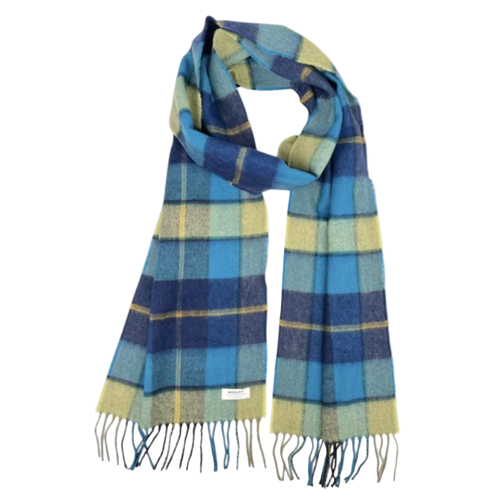 A plaid scarf in shades of blue, navy, yellow, and green, featuring fringed ends and a small white brand label near the bottom left, set against a plain white background.