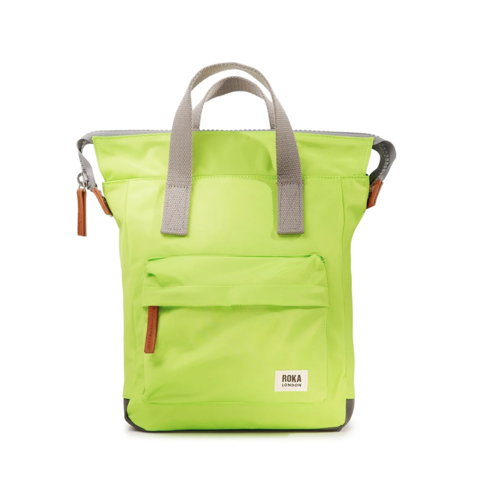 A yellow/green Roka Bantry B recycled nylon small backpack with a front pocket, two side handles, and a vegan pull zipper.