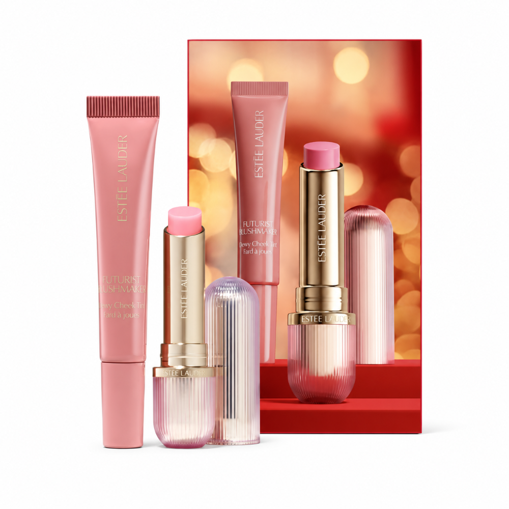 Estée Lauder Beauty Collection lip and cheek care set, featuring a pink tube of Futurist Blush, and a pink tube of Lip Balm arranged in front of a red and gold branded backdrop card.