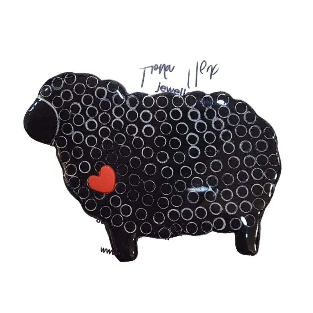Black sheep-shaped object with a red heart on a white background