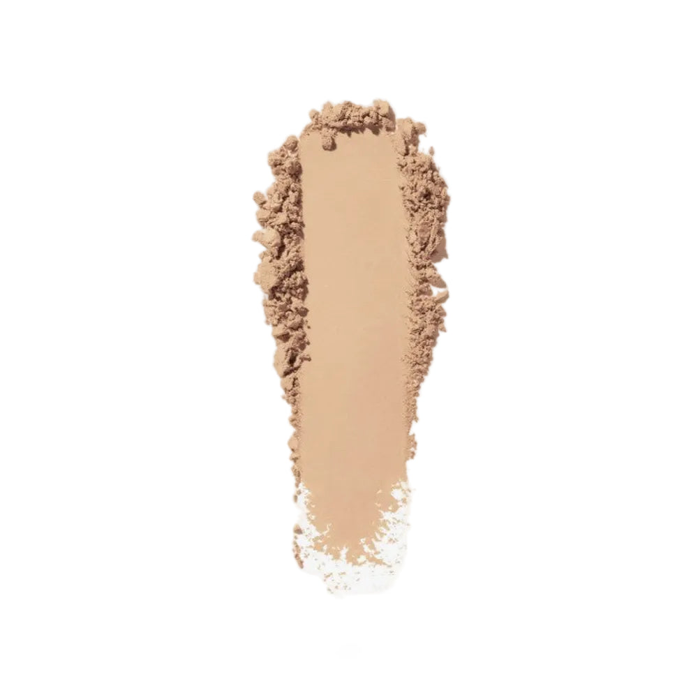 Beige makeup powder on a white background