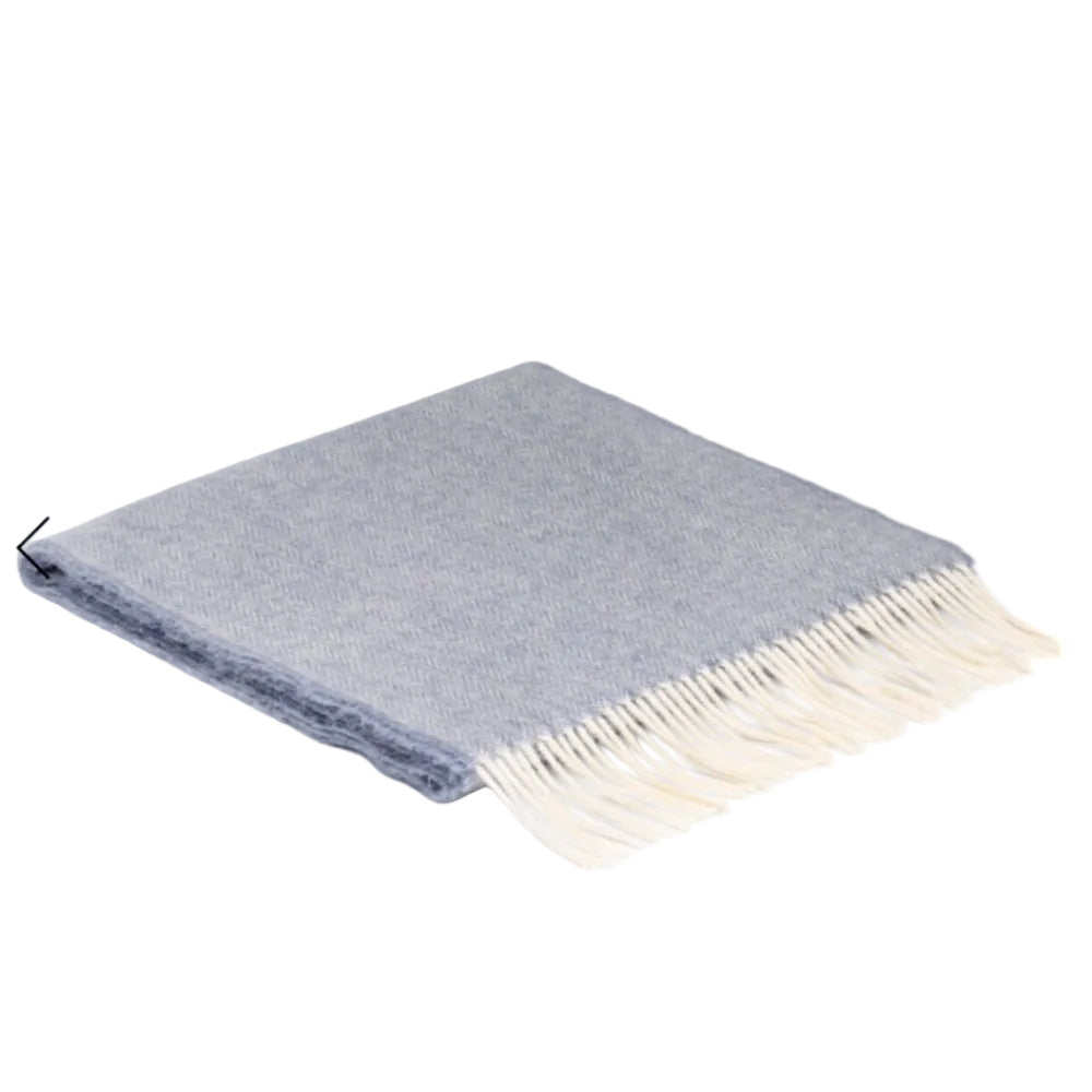 A light grey and light blue scarf with a herringbone pattern, made from wool, displayed on a white background.