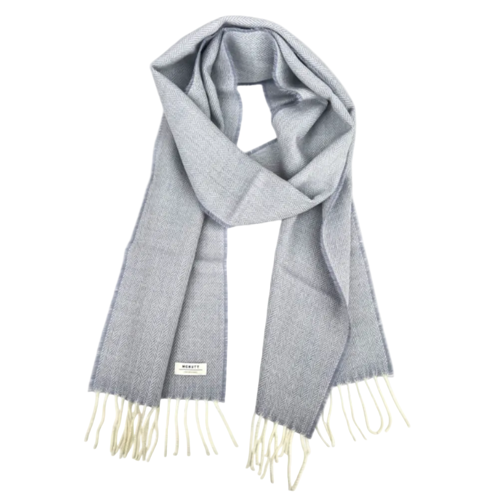 A light gray woven scarf with cream fringe ends and a small white brand label, displayed against a solid white background.