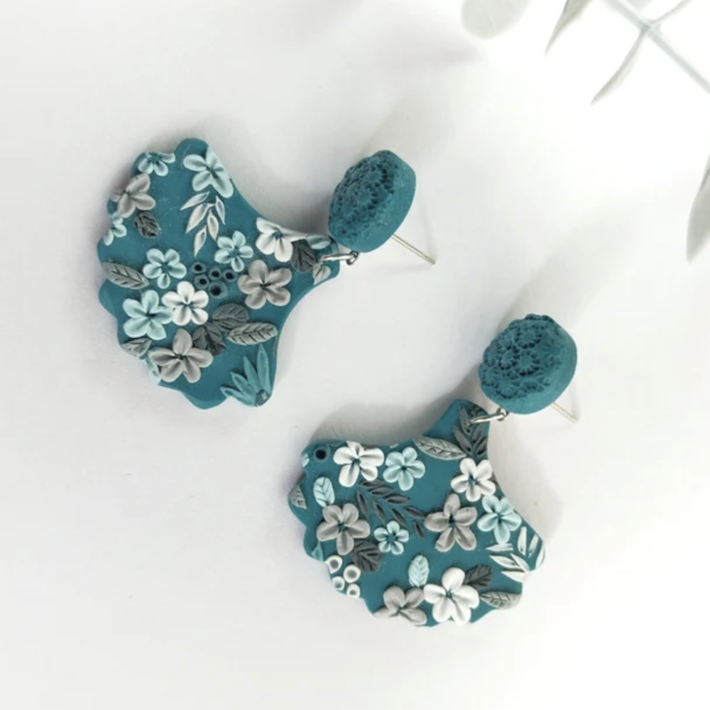 flower design earrings in teal background and colourful flowers