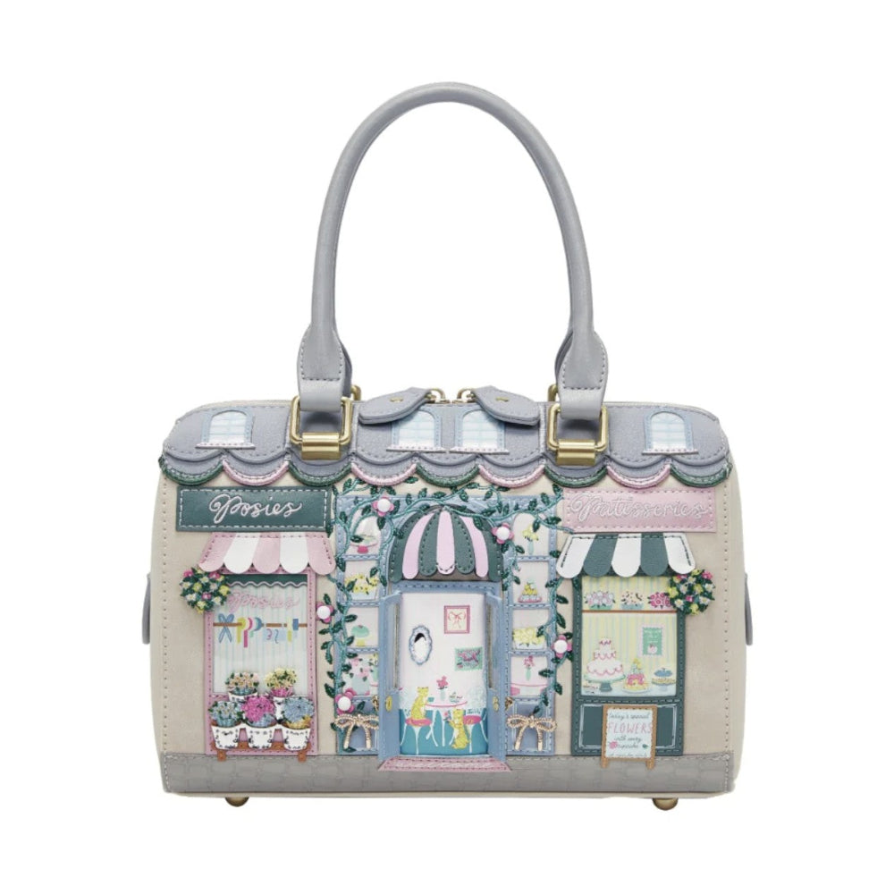 Handbag with a decorative design of a quaint street scene on a white background