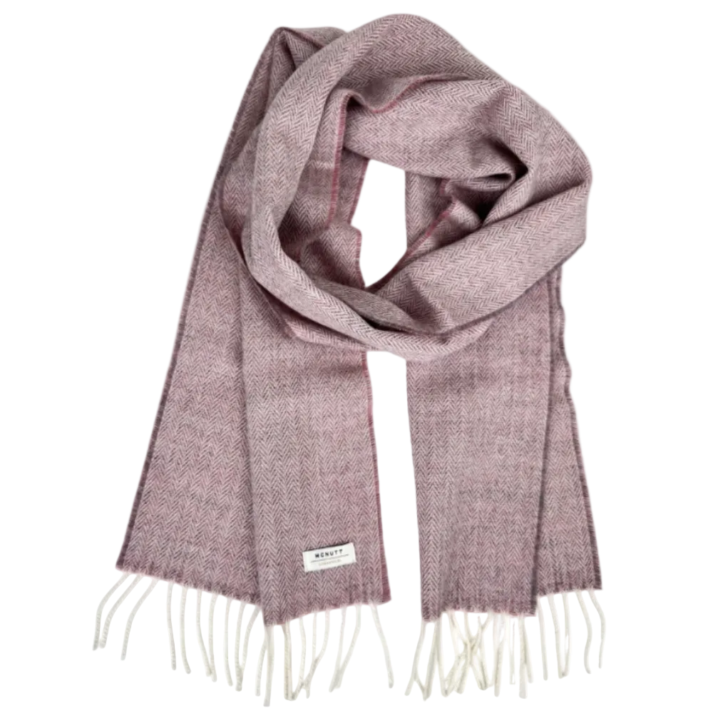 A dusty rose purple herringbone knit scarf with cream fringe and a small white brand label, displayed on a clean white background.