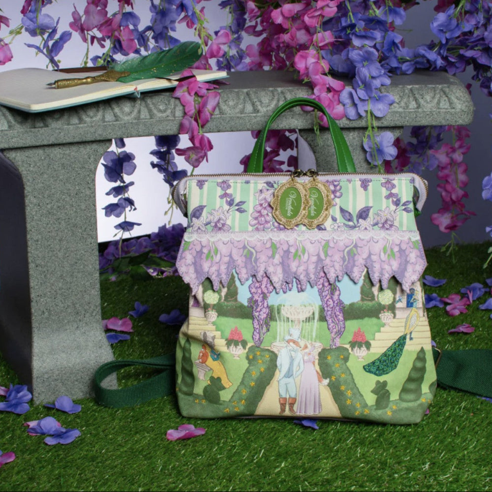 Handbag with garden design on a grassy surface with flowers in the background