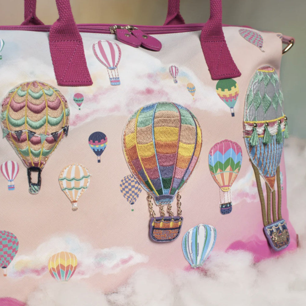 Handbag with colorful hot air balloon design on a pink background