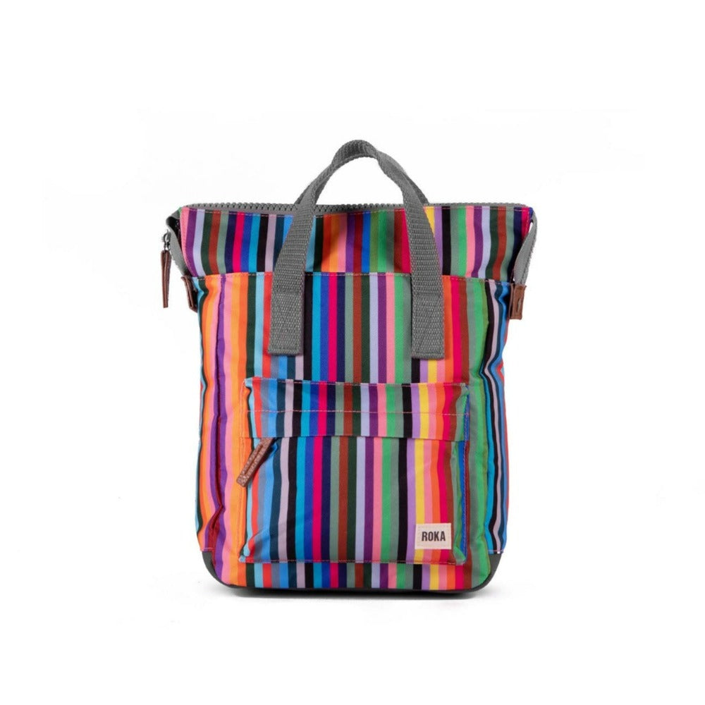 A small Roka Bantry B recycled canvas backpack with a blue geometric pattern, featuring a front pocket, two side handles and a vegan pull zipper.