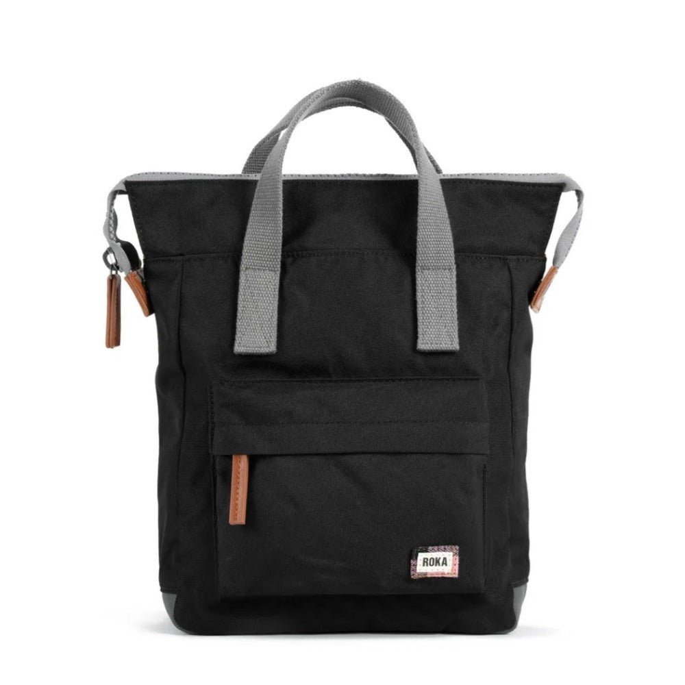 A brown Roka Bantry B small recycled canvas backpack with a front pocket, displayed against a white background.