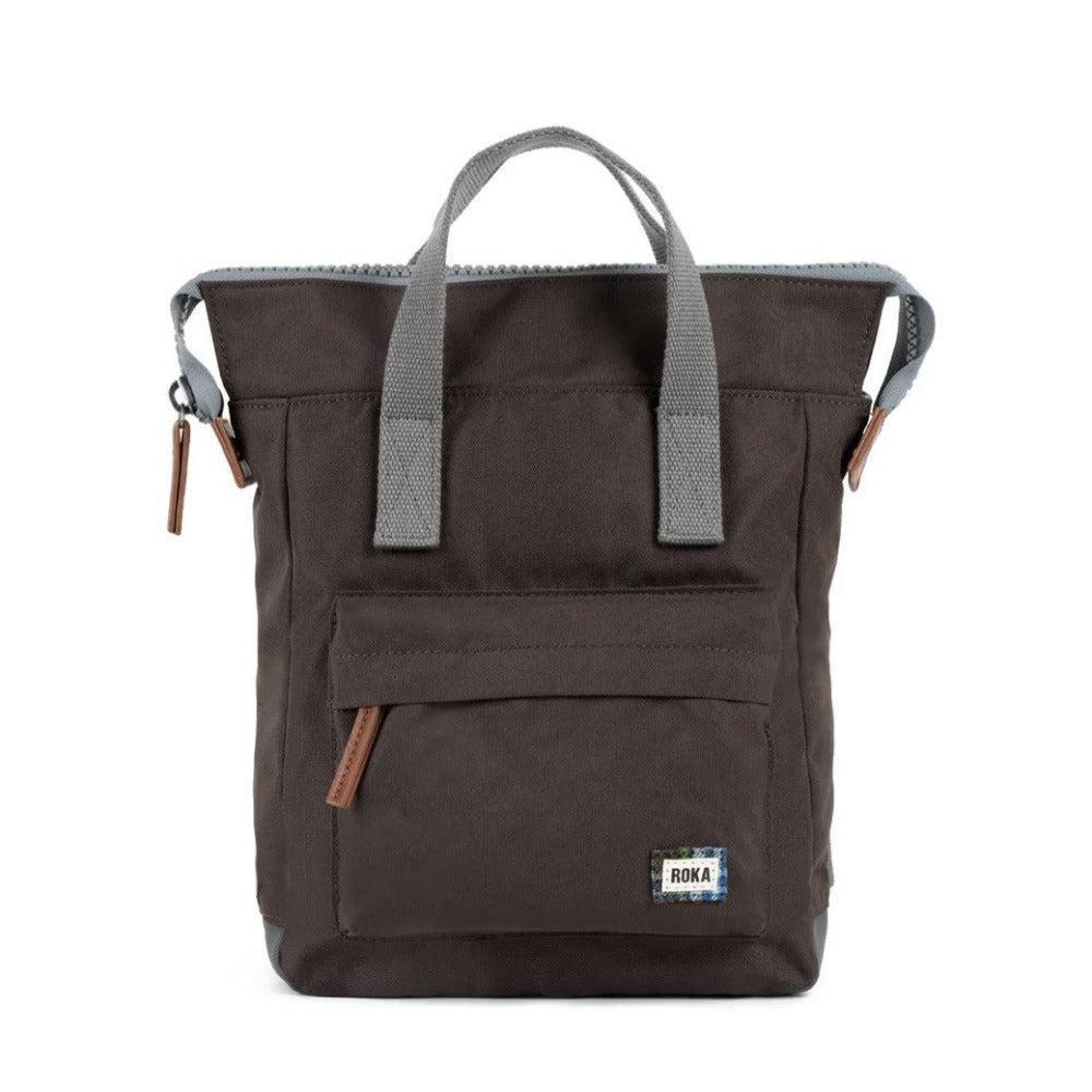 A brown Roka Bantry B small recycled canvas backpack with a front pocket, displayed against a white background.