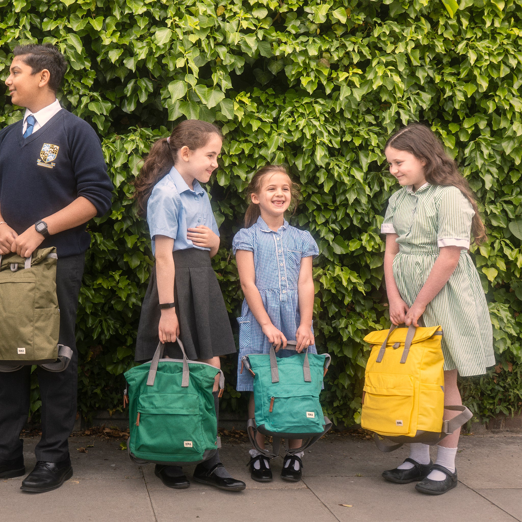 Roka Backpacks held by primary school children happy