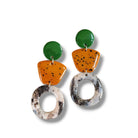 Colorful earrings with geometric shapes on a white background