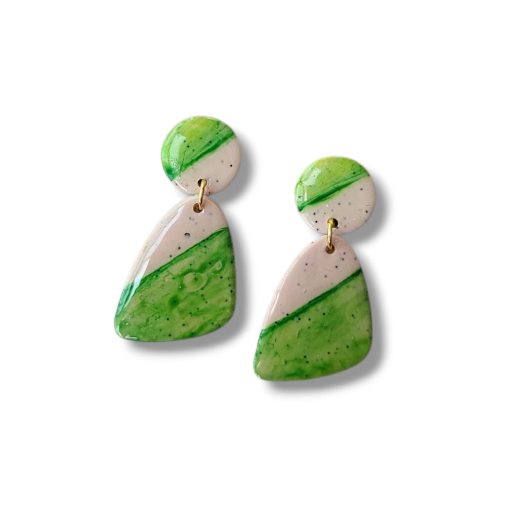 Pair of green and beige earrings on a white background