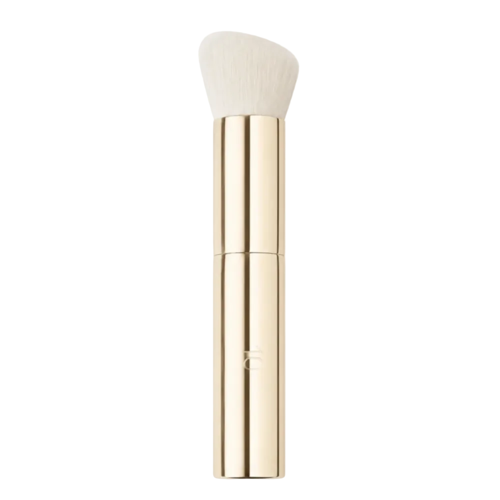 A slim makeup brush with a tapered, rounded brush head in off-white bristles, encased in a polished gold metallic handle, shown against a solid white background.