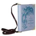A purple faux-leather crossbody bag designed to look like a vintage Alice in Wonderland book, featuring a dark brown leather shoulder strap and gold-tone hardware.