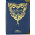 Blue book-shaped handbag with butterfly design and 'Moths and Butterflies' text on a white background