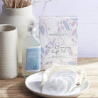 Herbalists by Nga gift set with face cleansing items on a wooden surface.