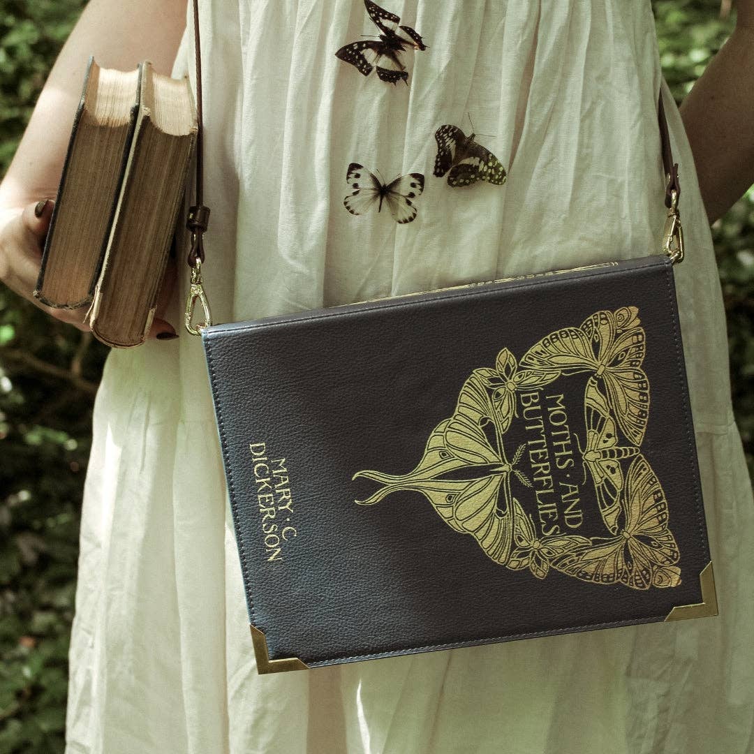 Blue book-shaped handbag with butterfly design and 'Moths and Butterflies' text 