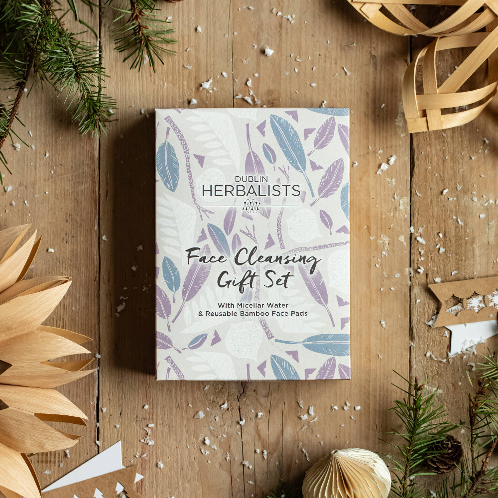 Herbalists Face Cleansing Gift Set packaging on a wooden surface with decorative elements.