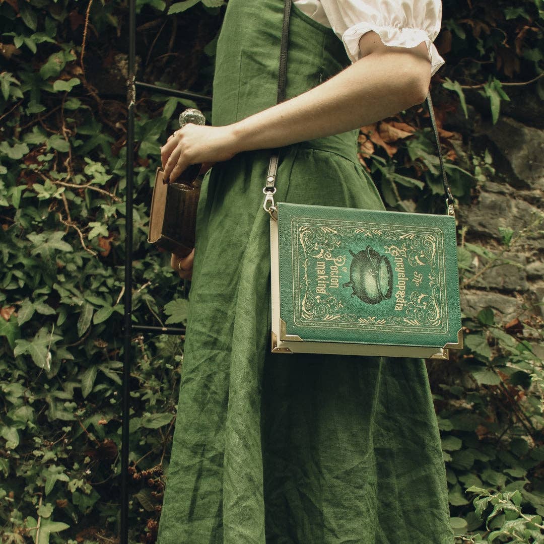 Green book-shaped bag with 'Encyclopedia of Potion Making' design on a white background