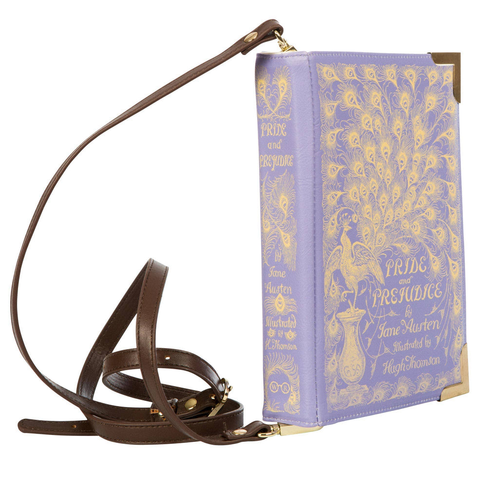 Book-shaped handbag with decorative cover on a white background