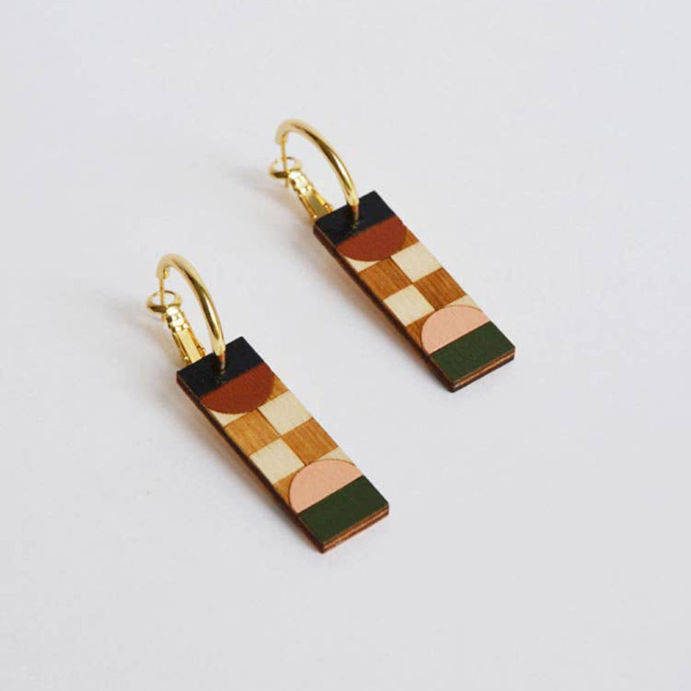 Pair of geometric patterned earrings on a light gray background