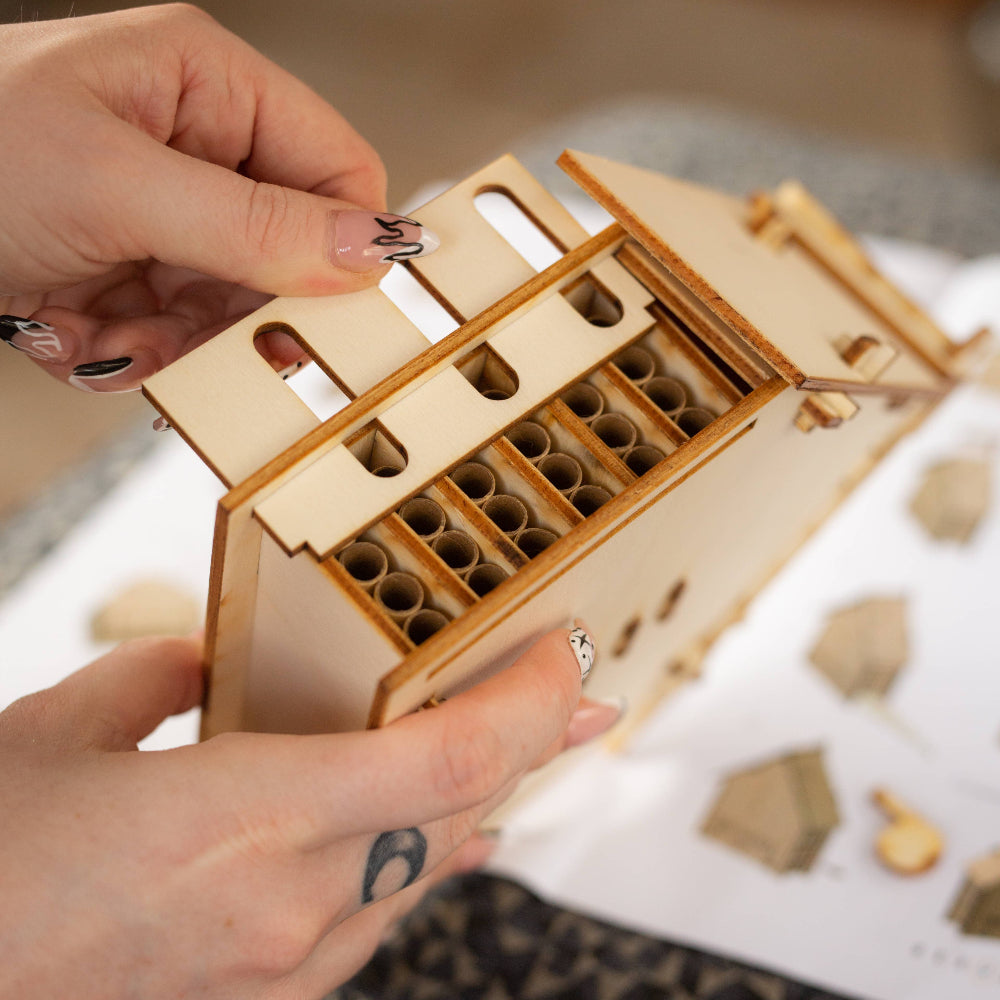 Wooden puzzle piece held by a hand with a blurred background