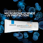 La Roche-Posay Cicaplast Baume B5+ UV-Protection with microbiome science and UV protection text on a black background with blue microscopic images.
