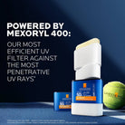 La Roche-Posay sunscreen stick with packaging and tennis ball on a blue background, featuring Mexoryl 400 technology.