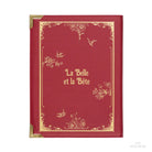 A red faux-leather crossbody bag designed to look like a vintage 'Beauty & the Beast' book, shown on a white background.