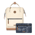 A cream-colored backpack with tan leather accents and a navy blue bandana-patterned zip pouch placed in front of it, shown on a clean white background.