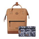 A tan leather and faux-leather backpack shown on a clean white background, with a matching zip pouch placed in front. The backpack has tan leather handles, a front zip pocket, and a circular logo patch.