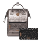 Metallic silver backpack with a matching pouch featuring a leopard print pattern on a white background.