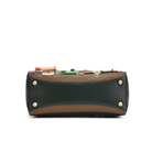 A structured leather clutch bag with a dark green pebbled texture, a tan leather trim, and gold-tone metal studs on the front, featuring a decorative collage of small colourful objects on the top flap, set against a plain white background.