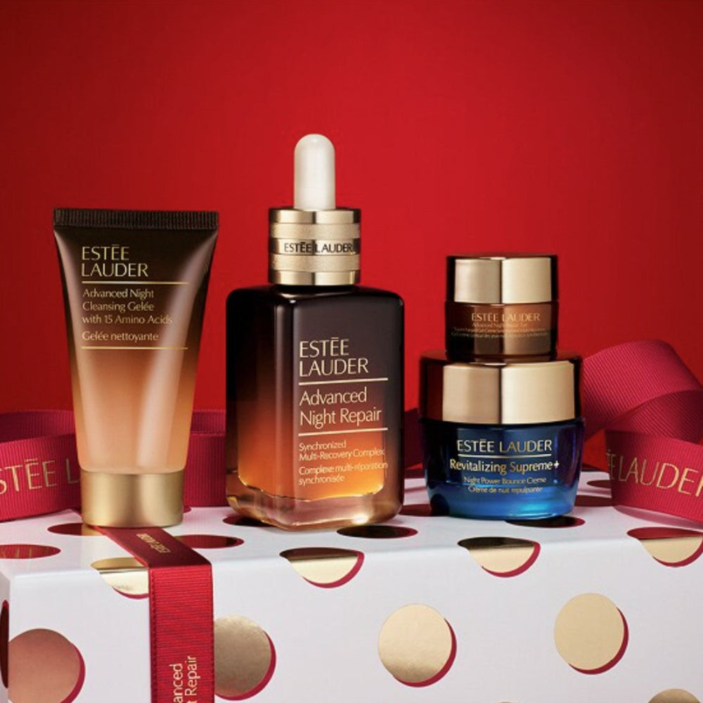 Estée Lauder skincare products on a red background