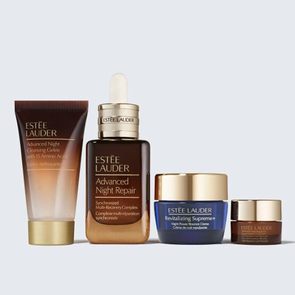Estée Lauder skincare products including a cleanser, serum, and creams on a light gray background.
