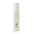 A cylindrical cosmetic bottle with a white cap and a cream-colored body, featuring the text 'ANTI REDNESS PRIMER' and a small gold floral emblem, set against a plain white background.