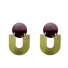 Pair of earrings with dark red circular tops and green U-shaped bases on a white background