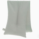 Folded light gray towel on a white background