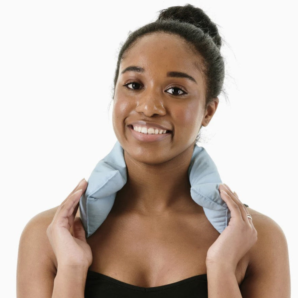 Woman using a neck pillow on a white background