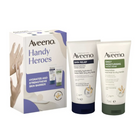 Aveeno Handy Heroes skincare set featuring a white and purple retail box alongside two tubes: Skin Relief Hand Cream with a dark navy cap and Daily Moisturising Hand Cream with a dark green cap, shown on a white background.