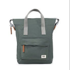 A thyme coloured bag with grey handles and brown leather accents, featuring a front pocket.