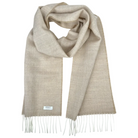 A light beige woven scarf with fringed ends, draped in a looped style on a solid white background. A small white brand label is visible near the bottom left edge.