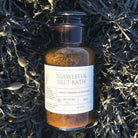 Bottle of Seaweed & Salt Bath on a bed of seaweed
