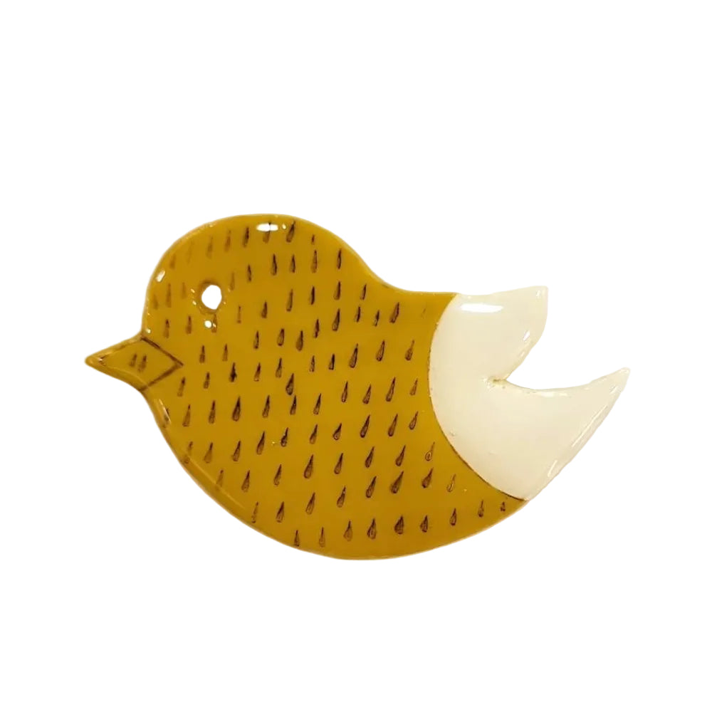 Yellow bird-shaped brooch pin on a white background