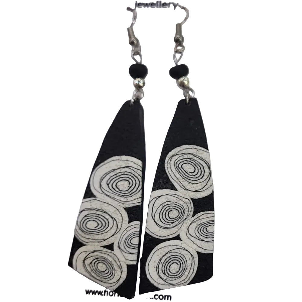 Black and white patterned earrings on a branded card against a white background